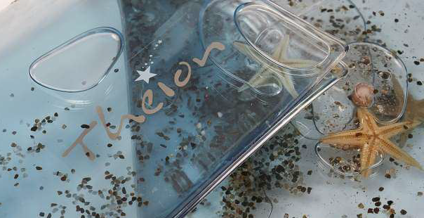 Encapsulation of sand & seashells, light blue liquid Encapsulation of sand & seashells, light blue liquid